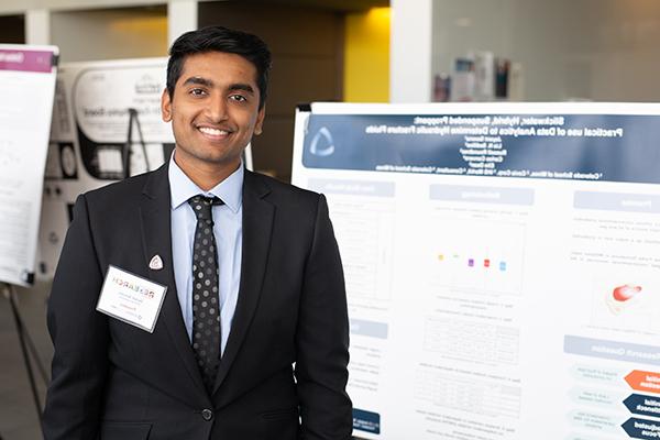 student standing by demo board